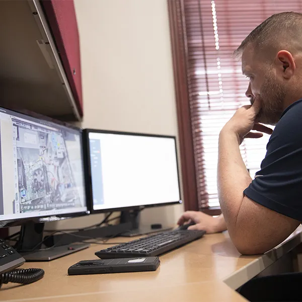 Simply Technology technician analyzing network systems during an IT assessment.