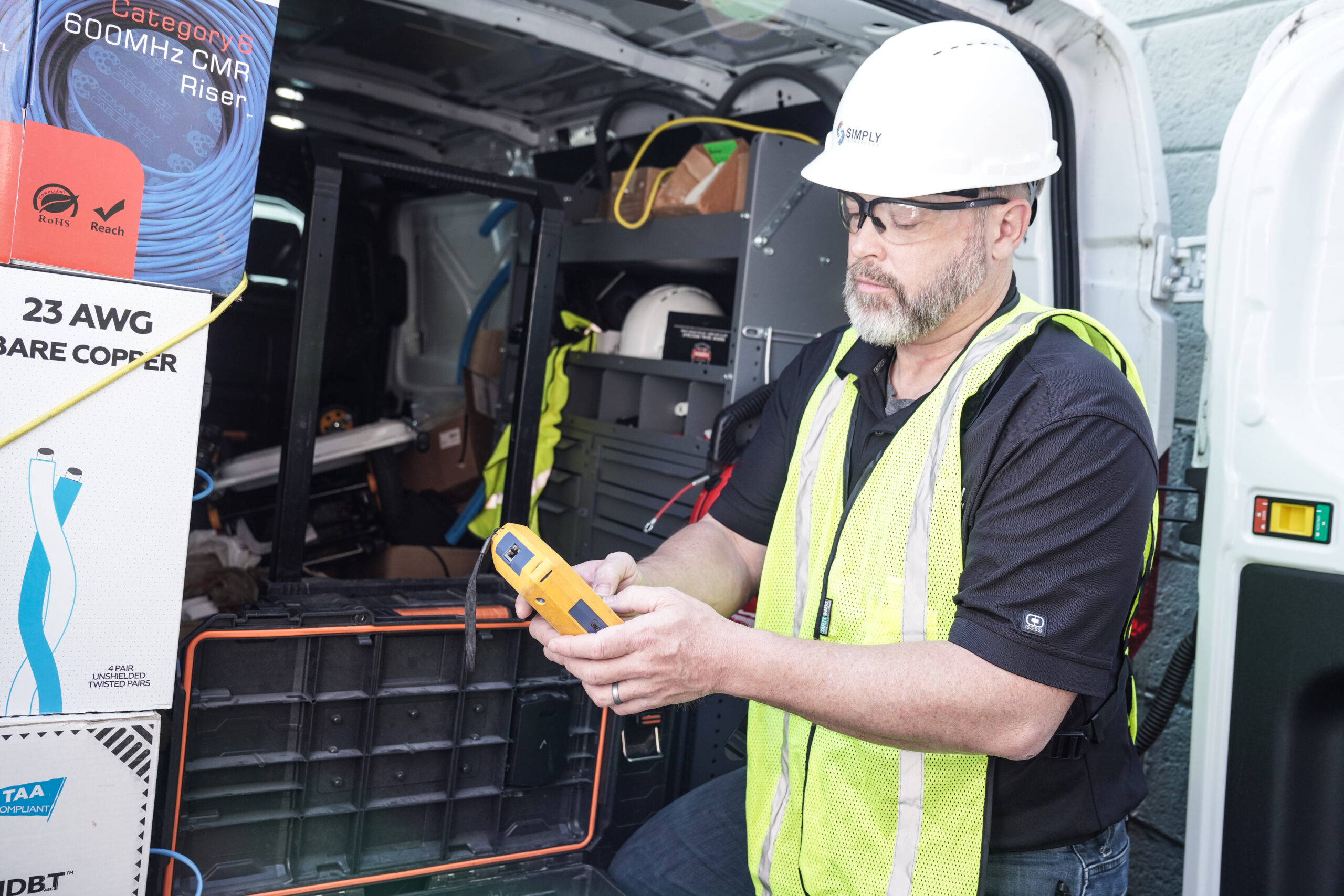 Simply Technology structured cabling technician testing a network cable run in Metro Detroit