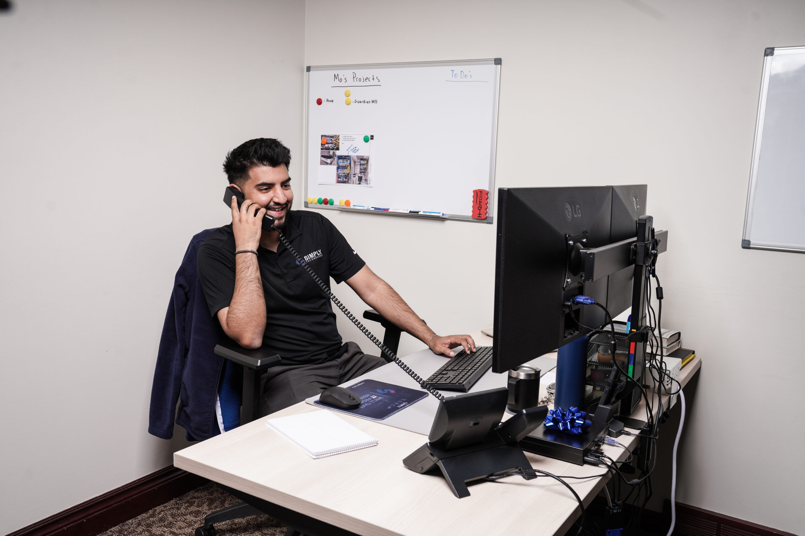 Simply Technology team member on a business phone call in Metro Detroit