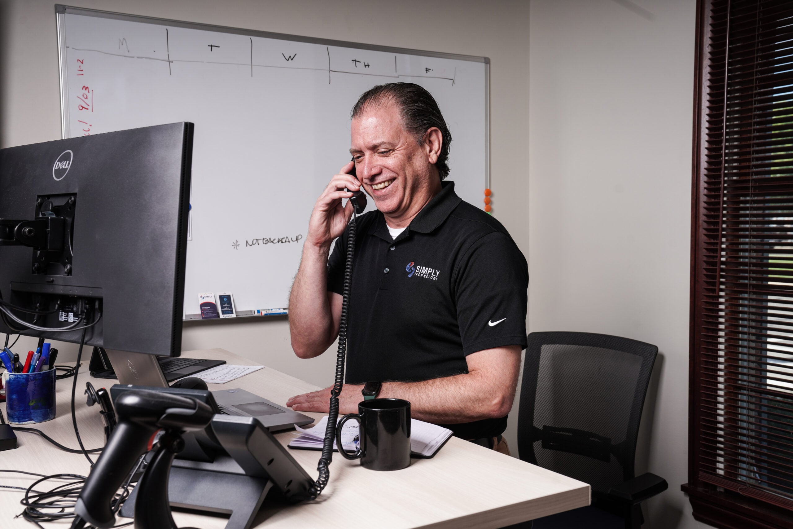 Simply Technology technician taking a client call at the Grosse Pointe Woods office