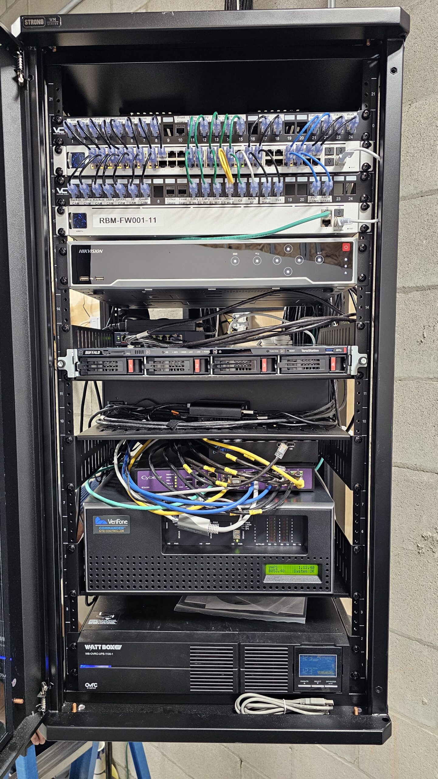 Business network rack with switches, firewall, patch panels, UPS, and cabling for a Metro Detroit office network